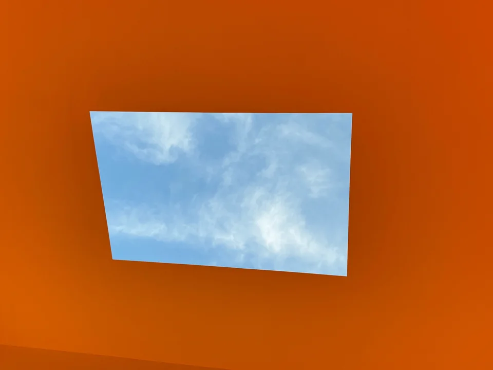 An orange room with a square opening onto the sky