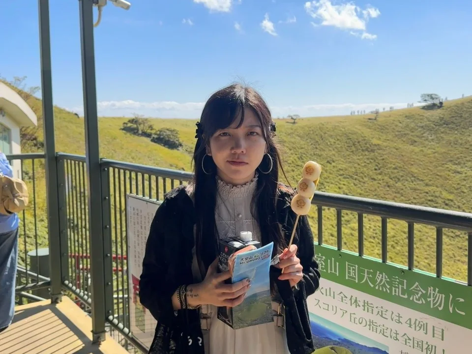 Holding dango on the Mount Omuro lookout in Izu