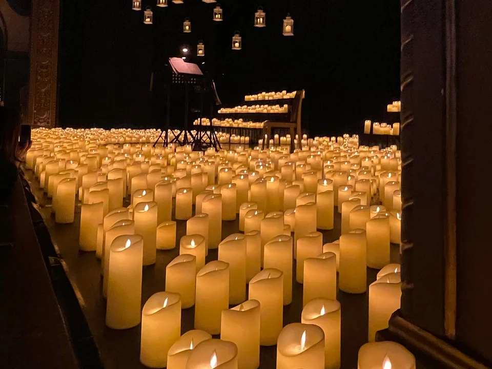 A candlelight concert, the stage covered in candles
